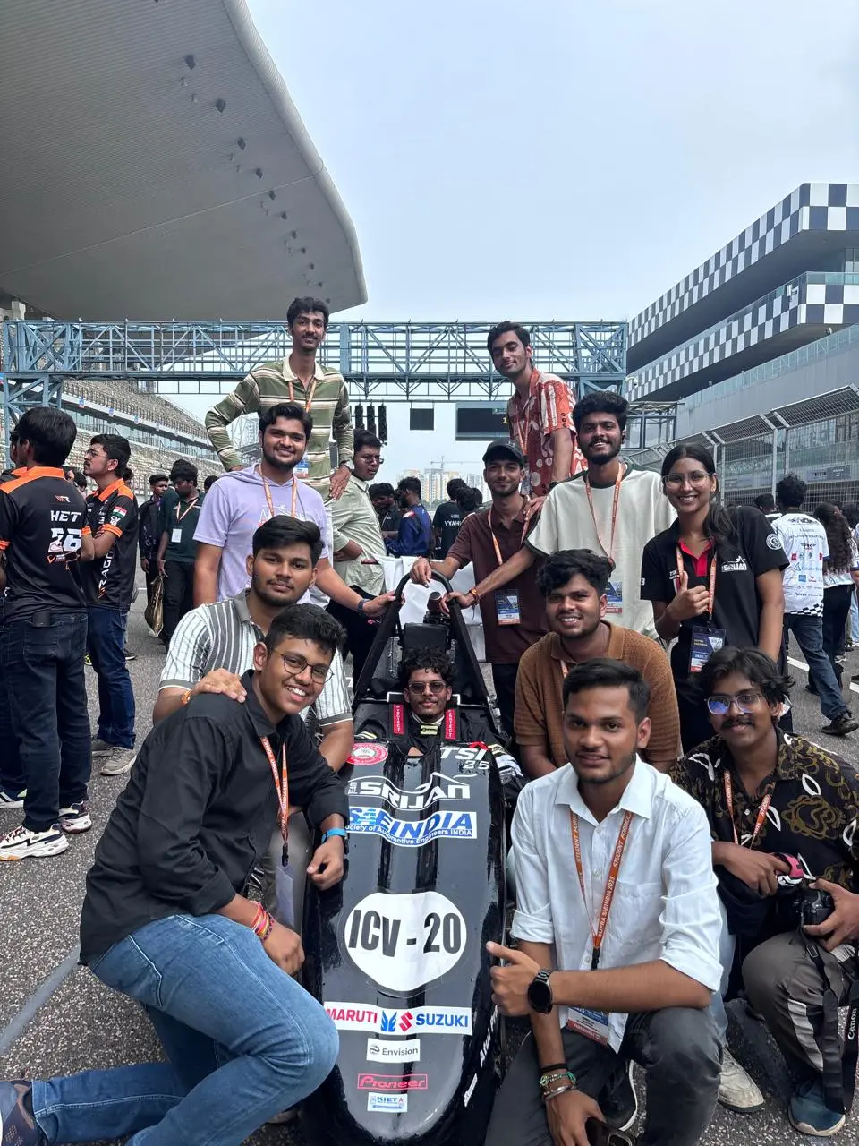 Team Srijan members with their Formula Student car at the competition track